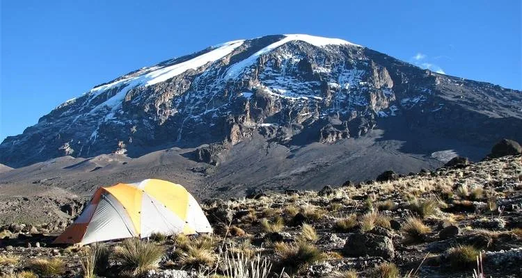 Panoramic view of Mount Kilimanjaro in Tanzania rising above the surrounding plains near Moshi, showing Africa's highest mountain and UNESCO World Heritage landscape.